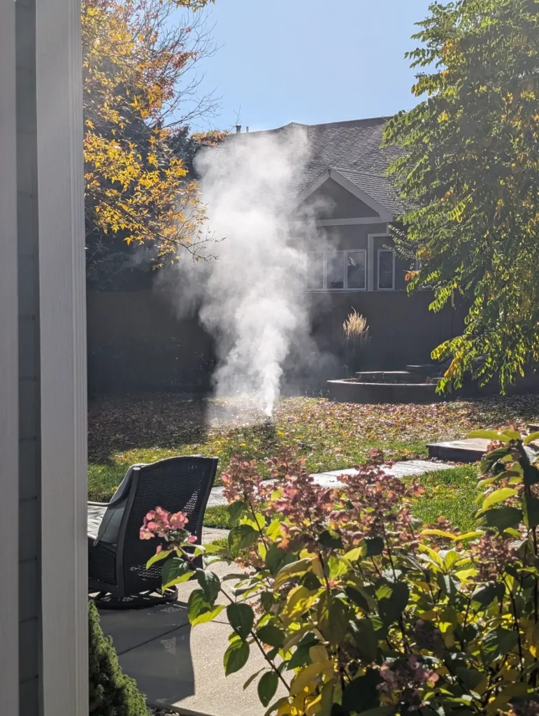 Home 3 - blow out web - Lotic Irrigation | Irrigation Repair & Lawn Maintenance | Fort Collins, CO | Experienced Professionals Compressed air blowing out a sprinkler backflow preventer at a Fort Collins home