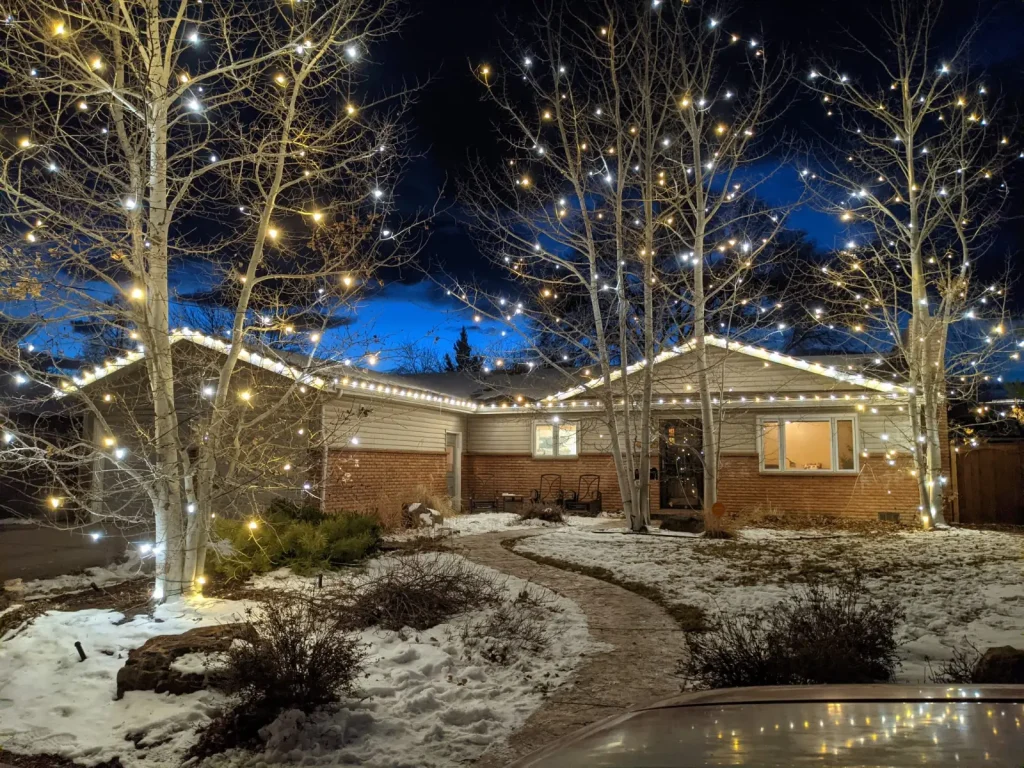 Home 4 - lights5 web - Lotic Irrigation | Irrigation Repair & Lawn Maintenance | Fort Collins, CO | Experienced Professionals Warm white holiday lights on a Fort Collins home and trees, installed by Lotic Irrigation